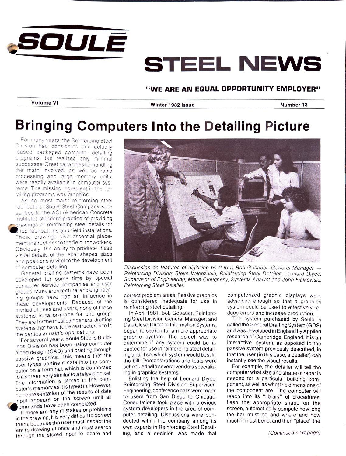 Four men working at computer terminals in an office.